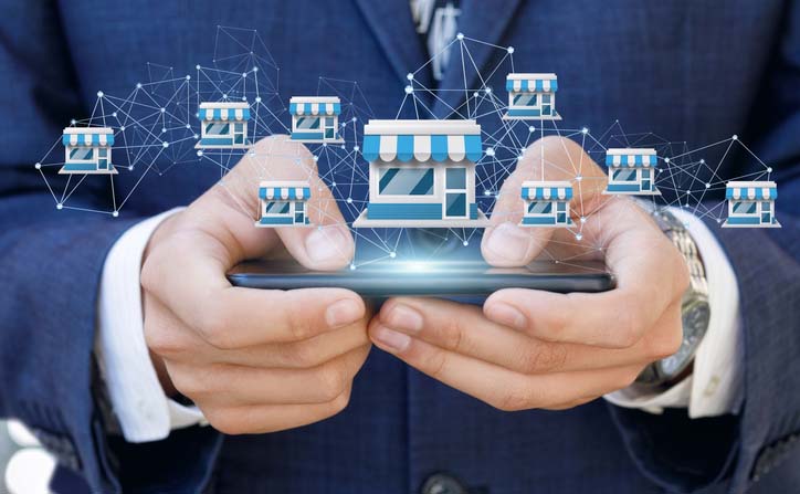 Businessman showing Franchise system on a mobile .