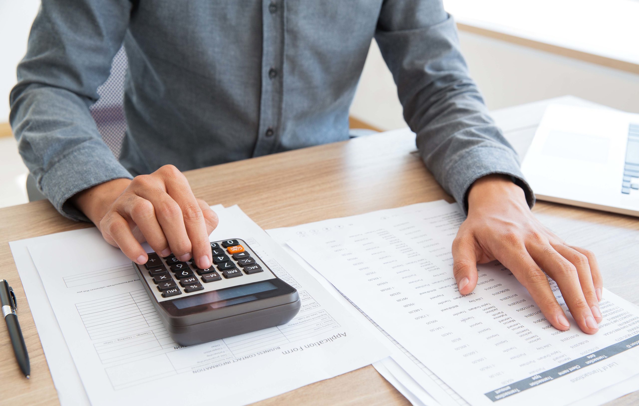 Accountant calculating income and examining report