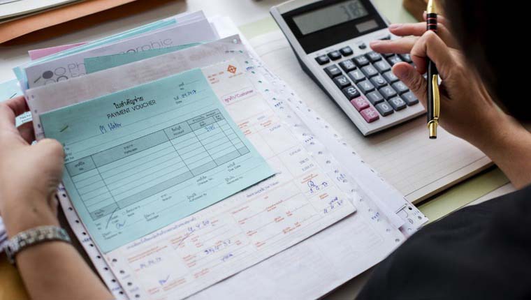 Asian woman working through paperwork