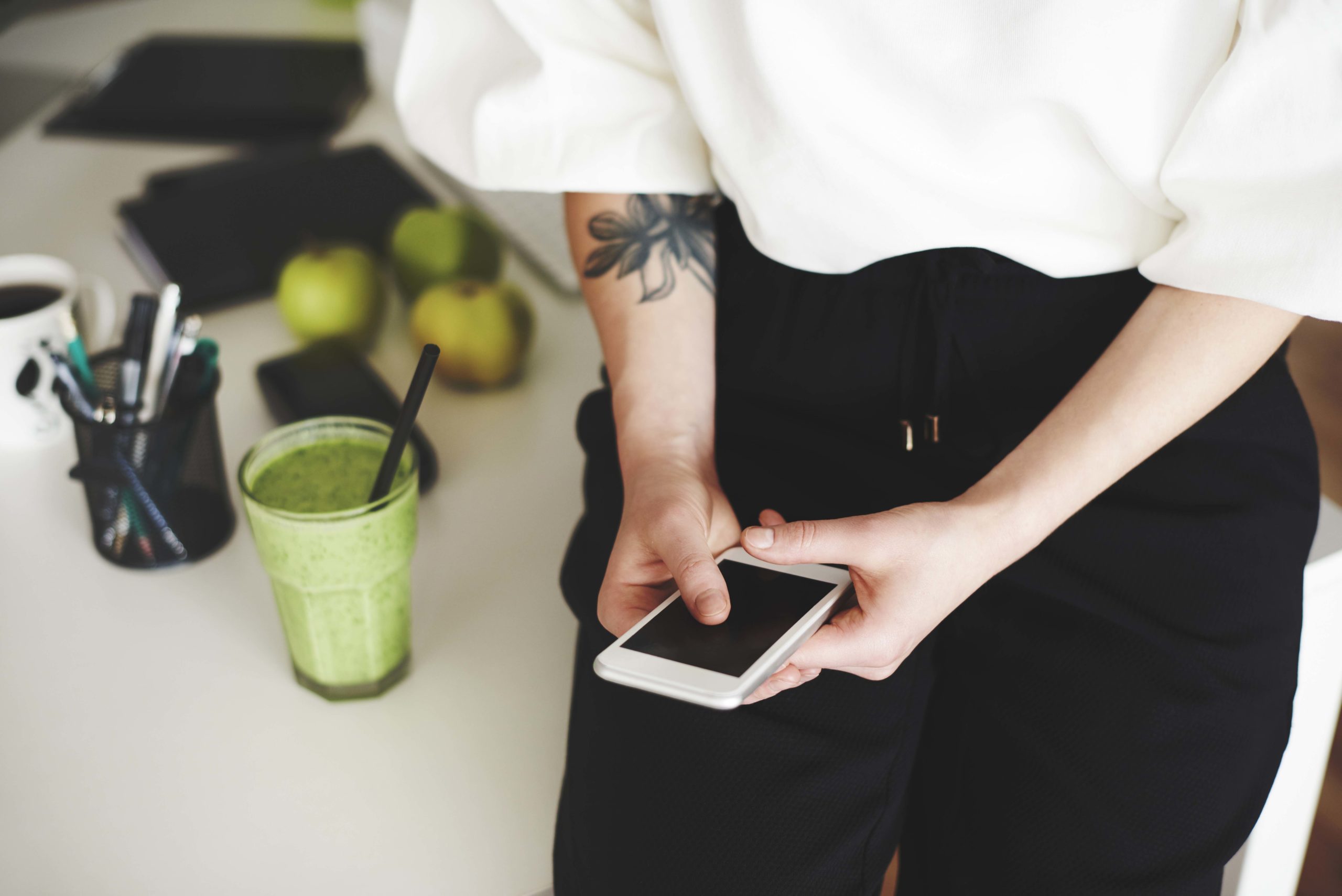 Woman with obscured face using mobilephone at home office