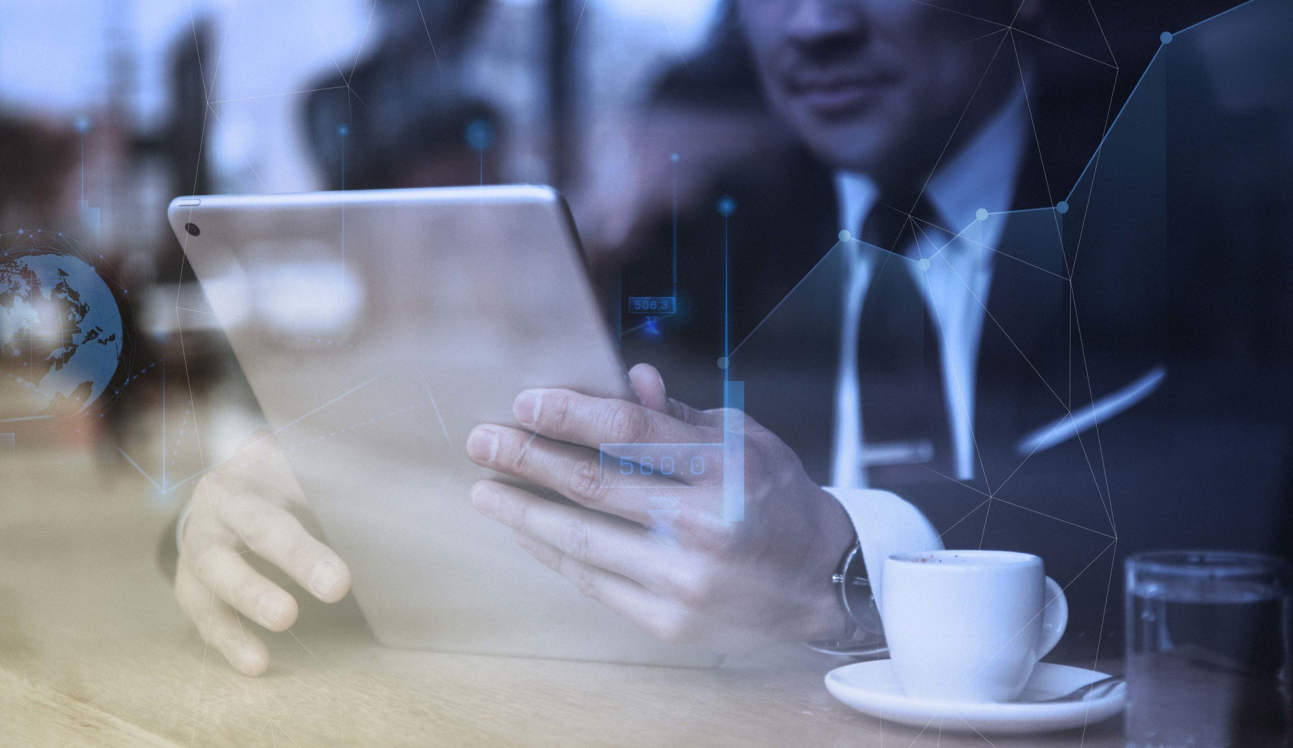 Businessman working on tablet in cafe