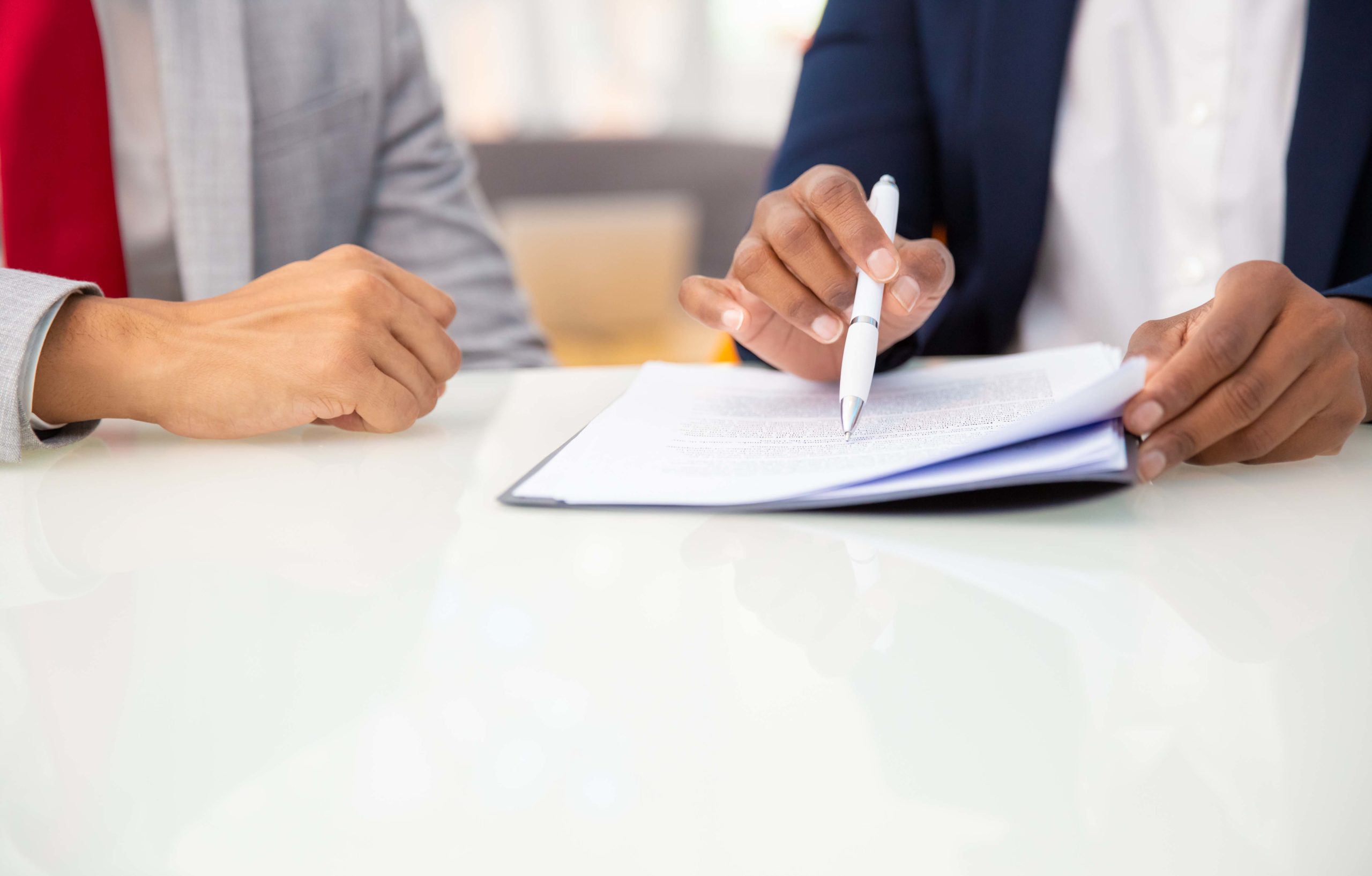 Cropped shot of business people reading contract